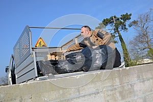 Garbage truck worker man collecting plastic