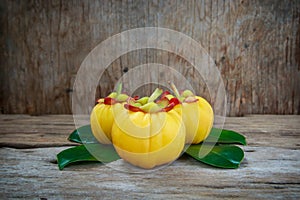 Garcinia cambogia fresh fruit on wood background. Fruit for die photo