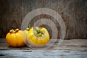 Garcinia cambogia fruit on wood background. Fruit for diet and