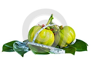 Garcinia cambogia with measuring tape, isolated on white backgro photo