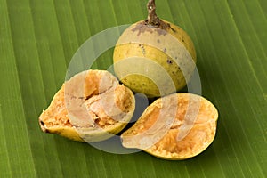 Garcinia, ripe fruit on a banana green leaf background.