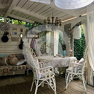 Garden arbour with rustic beige decoration, outdoor design. Handmade decorations and flowers.