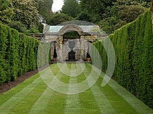 Garden architecture and sheared hedges and lawns in the park of Hever castle in England