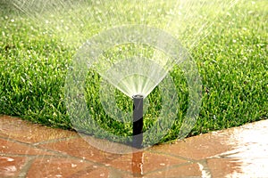 Garden automatic irrigation system watering lawn photo