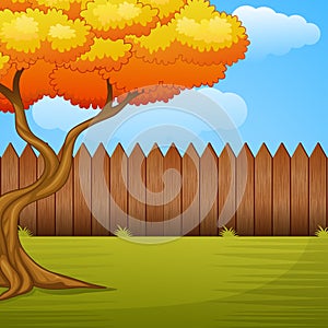 Garden background with autumn tree and wooden fence