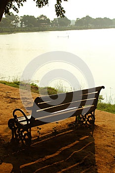 Garden bench on the rural lake shore