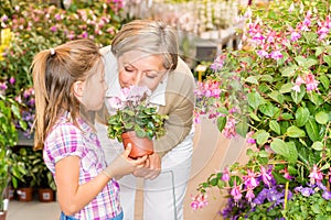 Garden center girl with grandmother smell flower