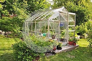 A garden center greenhouse with a colorful display of potted plants and flowers