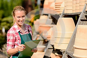 Garden center woman standing by clay pots