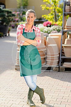 Garden center woman worker standing crossed arms