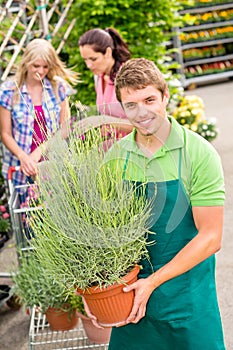 Garden centre worker hold potted plant