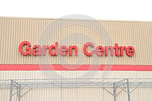 garden centre writing caption text on beige wall building above red line in red. p