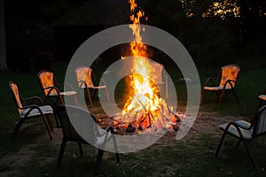 garden chairs circled around a bonfire