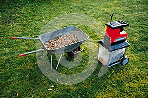 Garden chipper, electric shredder mulcher with wheelbarrow full of wooden mulch