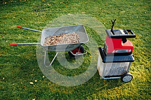 Garden chipper, electric shredder mulcher with wheelbarrow full of wooden mulch