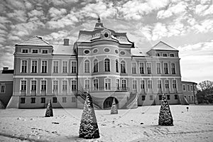 garden and classicist facade of the palace in the village of Rogalin during winter