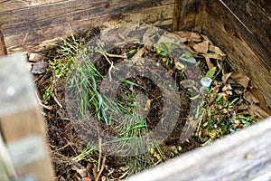Garden compost bin full of organic waste