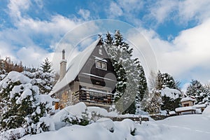 Garden cottage in winter morning after snowfall in the hill