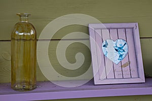 Garden decorations, glass bottle and heart in the frame