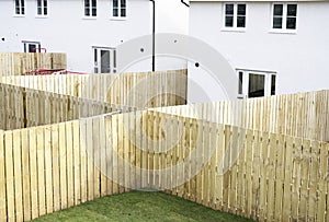 Garden fence made of wood planks across new build houses