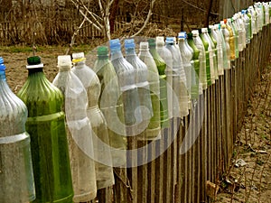 Garden fence with plastic bottles