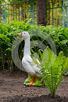 Garden figure of goose and lilies of the valley