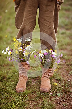 Garden flowers in boots in autumn season