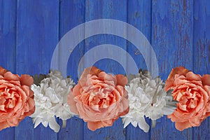 Garden flowers peony rose over blue wooden table background. Backdrop with copy space.