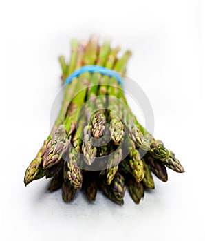 Garden fresh organic spring asparagus on white table cloth
