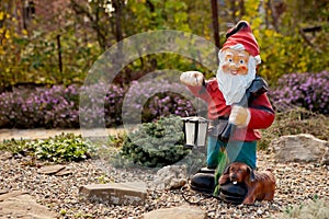 garden gnome on the background of a blooming garden