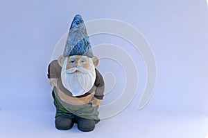 Garden Gnome with slipping pants and bare belly isolated against neutral background