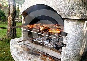 Garden grill with steaks and sausages