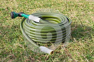 Garden hose green lawn new gardening equipment wrapped up coiled