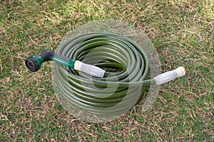 Garden hose green lawn new gardening equipment wrapped up coiled