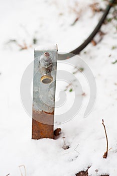 Garden hose and spout in the snow