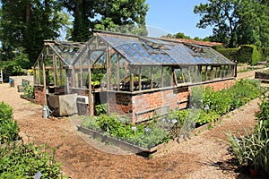 Garden with hothouses in Great Dixter House & Gardens in the summer.