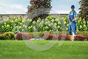 Garden Keeper Cleaning Residential Driveway Using Pressure Washer