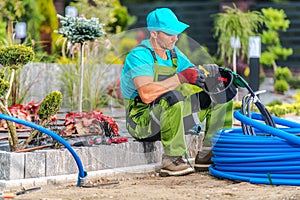 Garden Landscaper Building Backyard Irrigation System