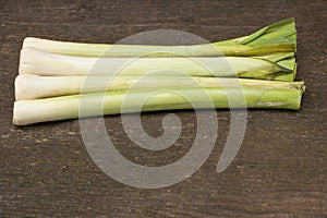 Garden leek benefits concept. Garden leek on wooden background