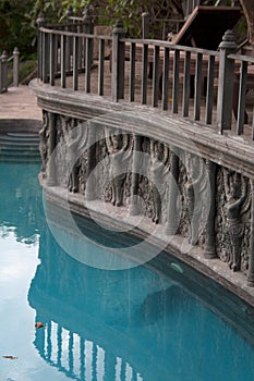 Garden lounge pool with stone sculptures and pilasters