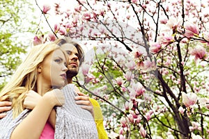 Garden with magnolia flower in spring, summer, man and woman