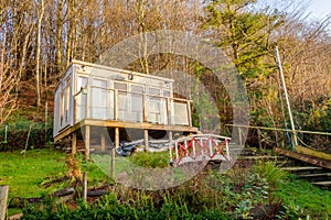 Garden office at the top of a landscaped garden beside a forest