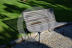 Garden park bench metal comfortable with construction with ergonomic curves of thin wood slats without visible screws gray brown