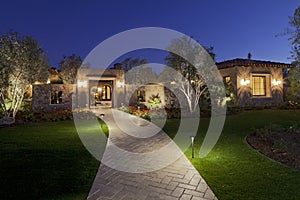 Garden path leading to residential front gate at dusk