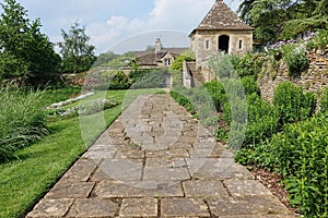 Garden Path Lined By Flowers and Lawn