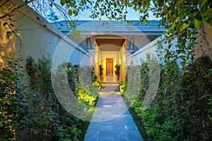 Garden path in resort with warm light and trees on side at evening, Garden Decoration