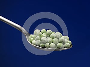 Garden pea on spoon