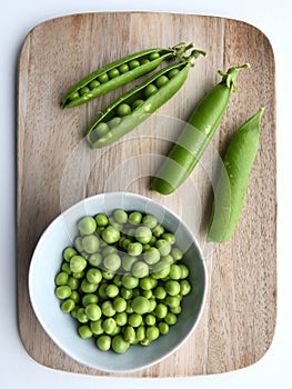 Garden peas (Pisum sativum) in the pod and in a bowl