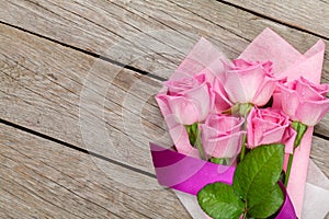 Garden pink roses bouquet over wooden table