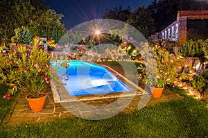 Garden with pool at night